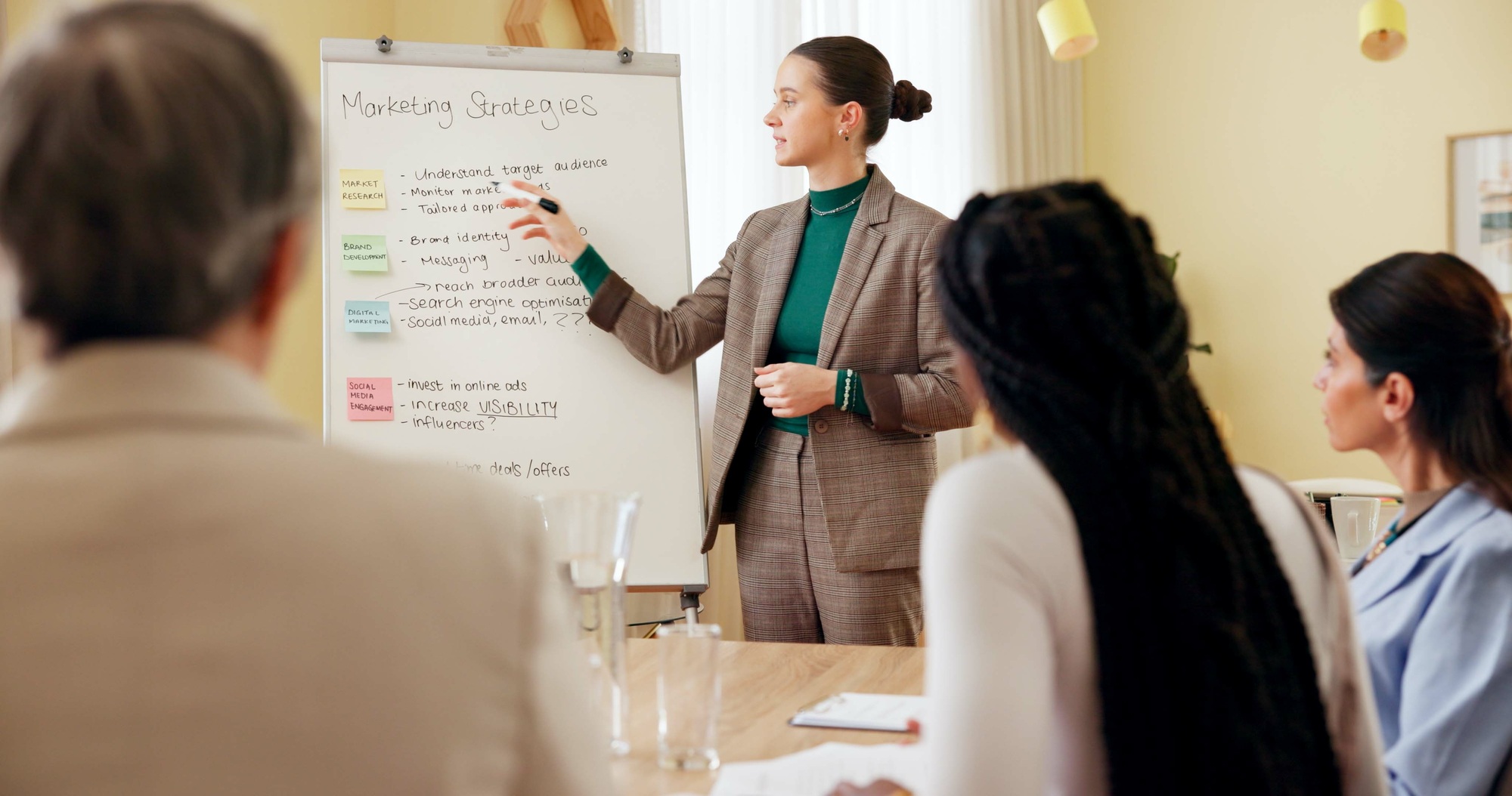 Business women, presentation and marketing meeting with speaker, whiteboard and management. Present